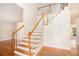Grand foyer with hardwood floors and a staircase featuring white spindles and wood handrail at 2164 Caneridge Sw Dr, Marietta, GA 30064