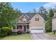Charming two-story home with stone accents, a covered porch, and an attached two-car garage at 2164 Caneridge Sw Dr, Marietta, GA 30064