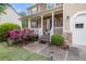 Inviting front porch with stone detailing, flowering bushes, and a walkway leading to the front door at 2164 Caneridge Sw Dr, Marietta, GA 30064