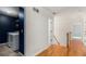 Upstairs hallway with hardwood floors, access to laundry room and other bedrooms at 2164 Caneridge Sw Dr, Marietta, GA 30064