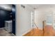 Upstairs hallway with laundry room featuring white appliances and contrasting paint at 2164 Caneridge Sw Dr, Marietta, GA 30064