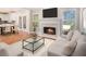 Bright and airy living room featuring a fireplace, comfortable seating, and views into the kitchen at 2164 Caneridge Sw Dr, Marietta, GA 30064