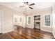 Bright living room featuring hardwood floors, fan and built-in bookcase at 2164 Caneridge Sw Dr, Marietta, GA 30064