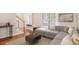 Cozy living room featuring a comfortable sectional sofa, hardwood floors, and a staircase at 2164 Caneridge Sw Dr, Marietta, GA 30064