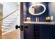 Stylish powder room featuring dark blue walls, decorative mirror, and elegant fixtures at 2164 Caneridge Sw Dr, Marietta, GA 30064