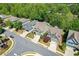 An aerial view of a residential neighborhood with tree-lined streets and manicured lawns at 235 Cornerstone Dr, Woodstock, GA 30188