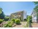 View of the home's backyard with a wood deck, patio, and lush green landscaping at 235 Cornerstone Dr, Woodstock, GA 30188