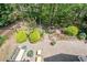 Aerial view of backyard with brick patio, seating, landscaping, and black fencing at 235 Cornerstone Dr, Woodstock, GA 30188