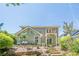Exterior view of the home showcasing a charming backyard, including a stone patio, landscaping, and a small deck at 235 Cornerstone Dr, Woodstock, GA 30188