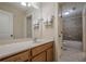 Bright bathroom featuring vanity, sink, and tiled tub/shower combo at 235 Cornerstone Dr, Woodstock, GA 30188