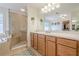 Well-lit bathroom featuring double vanity, glass enclosed shower and large soaking tub at 235 Cornerstone Dr, Woodstock, GA 30188