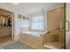 Bathroom with soaking tub, glass enclosed shower, and walk-in closet at 235 Cornerstone Dr, Woodstock, GA 30188
