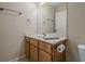 Cozy bathroom featuring a wooden vanity with white countertop and a decorative towel rack at 235 Cornerstone Dr, Woodstock, GA 30188