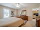 Spacious bedroom featuring a ceiling fan, a bed, and a dresser with traditional decor at 235 Cornerstone Dr, Woodstock, GA 30188