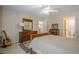 Bright bedroom with a ceiling fan, a wooden dresser, and an ensuite bathroom for convenience at 235 Cornerstone Dr, Woodstock, GA 30188
