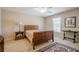 Comfortable bedroom with wooden furniture, a ceiling fan, and natural light from the window at 235 Cornerstone Dr, Woodstock, GA 30188