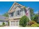 Side view of a gray two-story home with an American flag, showcasing its manicured landscaping at 235 Cornerstone Dr, Woodstock, GA 30188