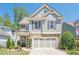 Charming two-story home with gray siding, stone accents, and a well-manicured front yard at 235 Cornerstone Dr, Woodstock, GA 30188