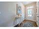 Bright foyer featuring hardwood floors, elegant decor, and a welcoming front door at 235 Cornerstone Dr, Woodstock, GA 30188