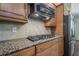 The gourmet kitchen includes stainless steel appliances, granite countertops, and custom cabinets at 235 Cornerstone Dr, Woodstock, GA 30188