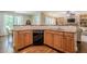 This kitchen includes a black dishwasher, granite countertops, and custom cabinets at 235 Cornerstone Dr, Woodstock, GA 30188