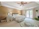 Serene main bedroom featuring a tray ceiling, fireplace, and access to a private balcony at 235 Cornerstone Dr, Woodstock, GA 30188
