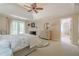 Comfortable main bedroom with fireplace, ensuite bathroom, and access to a private balcony at 235 Cornerstone Dr, Woodstock, GA 30188