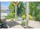 Relaxing patio area with stone pavers, comfortable seating, and well-maintained landscaping for outdoor living at 235 Cornerstone Dr, Woodstock, GA 30188