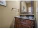 Stylish powder room with a decorative mirror, elegant vanity, and neutral color scheme at 235 Cornerstone Dr, Woodstock, GA 30188