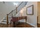 Staircase featuring hardwood floors, a piano, and elegant decor at 235 Cornerstone Dr, Woodstock, GA 30188