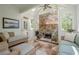 Charming sunroom with stone fireplace, skylights, and views of the surrounding greenery at 235 Cornerstone Dr, Woodstock, GA 30188