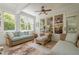 Relaxing sunroom with large windows, comfortable seating, and a serene atmosphere at 235 Cornerstone Dr, Woodstock, GA 30188