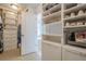 Custom walk-in closet with shelving for shoes and drawers for clothing at 235 Cornerstone Dr, Woodstock, GA 30188
