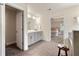 Well-lit bathroom with double sinks, tile floors, and direct access to bedroom at 3051 Mountain Shadow Way, Marietta, GA 30064
