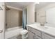 Bathroom featuring a shower-tub combo, white vanity with sink, and a large mirror with vanity lighting at 3051 Mountain Shadow Way, Marietta, GA 30064