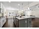 Modern kitchen features an island with seating, stainless steel appliances, and hardwood floors at 3051 Mountain Shadow Way, Marietta, GA 30064