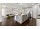 Spacious kitchen with center island flowing into the living area, perfect for entertaining at 3051 Mountain Shadow Way, Marietta, GA 30064