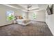 Spacious main bedroom featuring a tray ceiling, carpeted floors, and three large windows at 3051 Mountain Shadow Way, Marietta, GA 30064