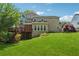 Spacious home backyard featuring a lush lawn, mature trees, and a wooden deck at 579 Delphinium Nw Blvd, Acworth, GA 30102