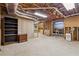 Unfinished basement area featuring exposed ceiling, concrete floors, shelving, and ample open space at 579 Delphinium Nw Blvd, Acworth, GA 30102