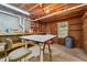Unfinished basement featuring concrete flooring, walls with shelving, and work bench at 579 Delphinium Nw Blvd, Acworth, GA 30102