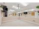 Finished basement with large mirrors, neutral paint, carpet, and a ceiling fan at 579 Delphinium Nw Blvd, Acworth, GA 30102