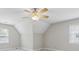Bright bedroom with a ceiling fan, neutral paint, carpet, and two large double-hung windows at 579 Delphinium Nw Blvd, Acworth, GA 30102