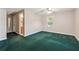 Bedroom with green carpet, neutral walls, and an entry to the bathroom at 579 Delphinium Nw Blvd, Acworth, GA 30102
