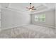 Spacious main bedroom features a tray ceiling, ceiling fan, neutral carpeting, and plenty of natural light at 579 Delphinium Nw Blvd, Acworth, GA 30102