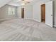 Large bedroom with neutral paint, plush carpeting, ceiling fan, and two entry doors at 579 Delphinium Nw Blvd, Acworth, GA 30102