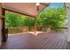 Expansive wooden deck with a ceiling fan overlooking a lush green backyard at 579 Delphinium Nw Blvd, Acworth, GA 30102