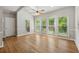 Sun-lit dining room features hardwood floors, a ceiling fan, skylights, and beautiful backyard views through large picture windows at 579 Delphinium Nw Blvd, Acworth, GA 30102