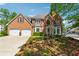 Lovely two-story brick home featuring an attached two-car garage and a well-maintained lawn at 579 Delphinium Nw Blvd, Acworth, GA 30102