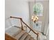 Grand foyer featuring hardwood and tile flooring, stairs with carpet, a decorative chandelier, and a leaded glass window at 579 Delphinium Nw Blvd, Acworth, GA 30102